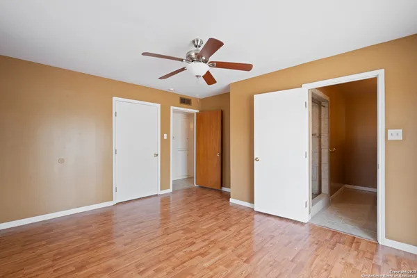 a view of room with wooden floor ceiling fan and window