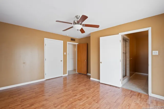 a view of room with wooden floor ceiling fan and window