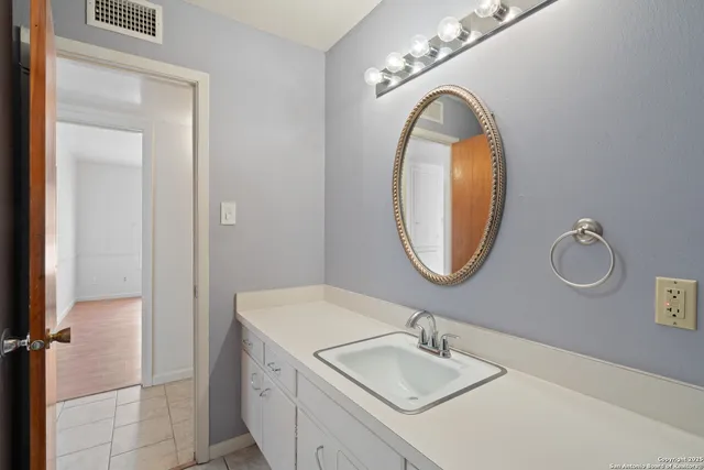 a bathroom with a sink and a mirror