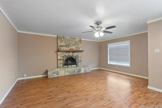 a view of empty room with fan and window