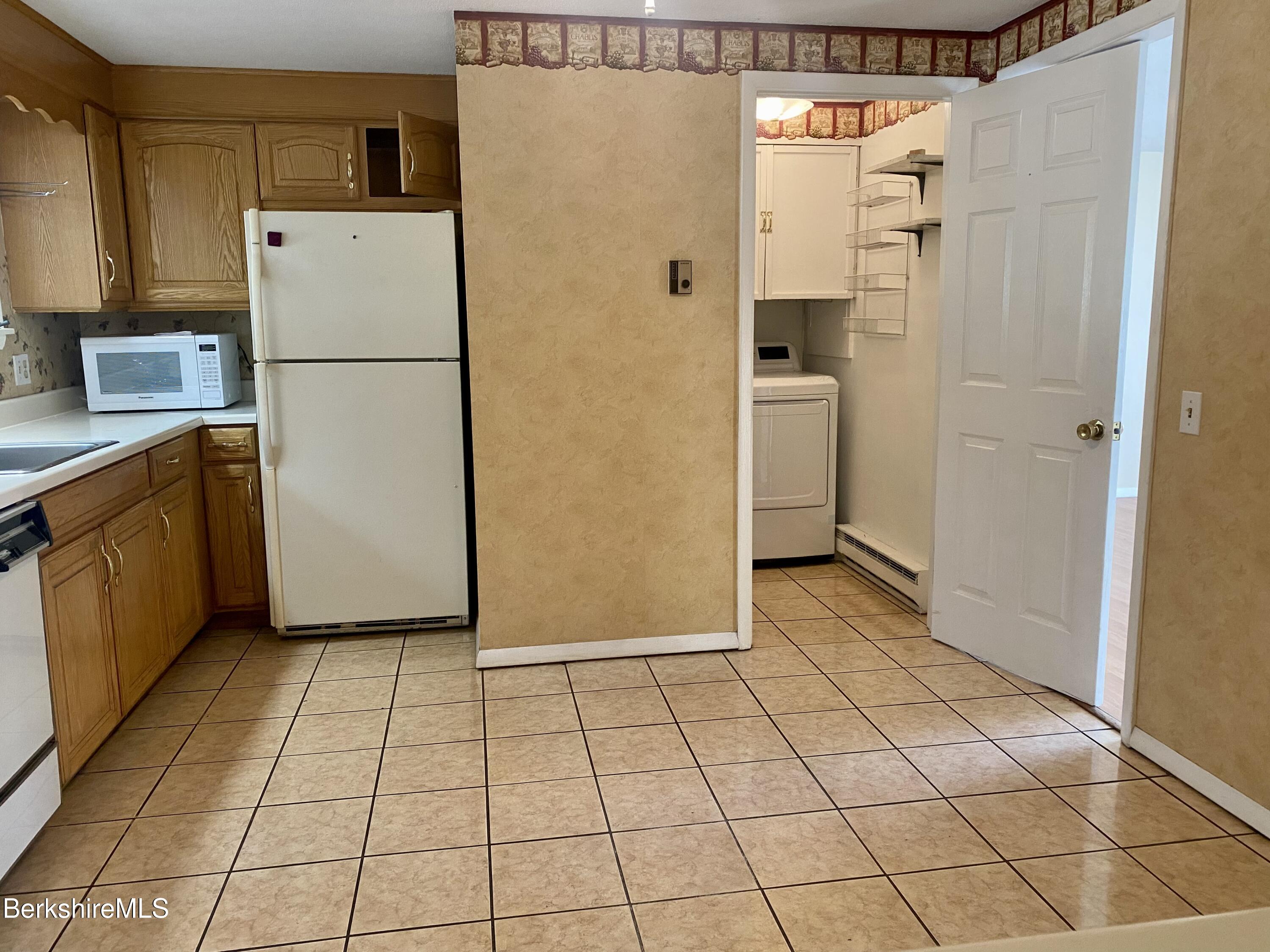 44 Eleanor Road Dalton, MA 01226 - Photo 11 of 36 a kitchen with a refrigerator a stove top oven and cabinets