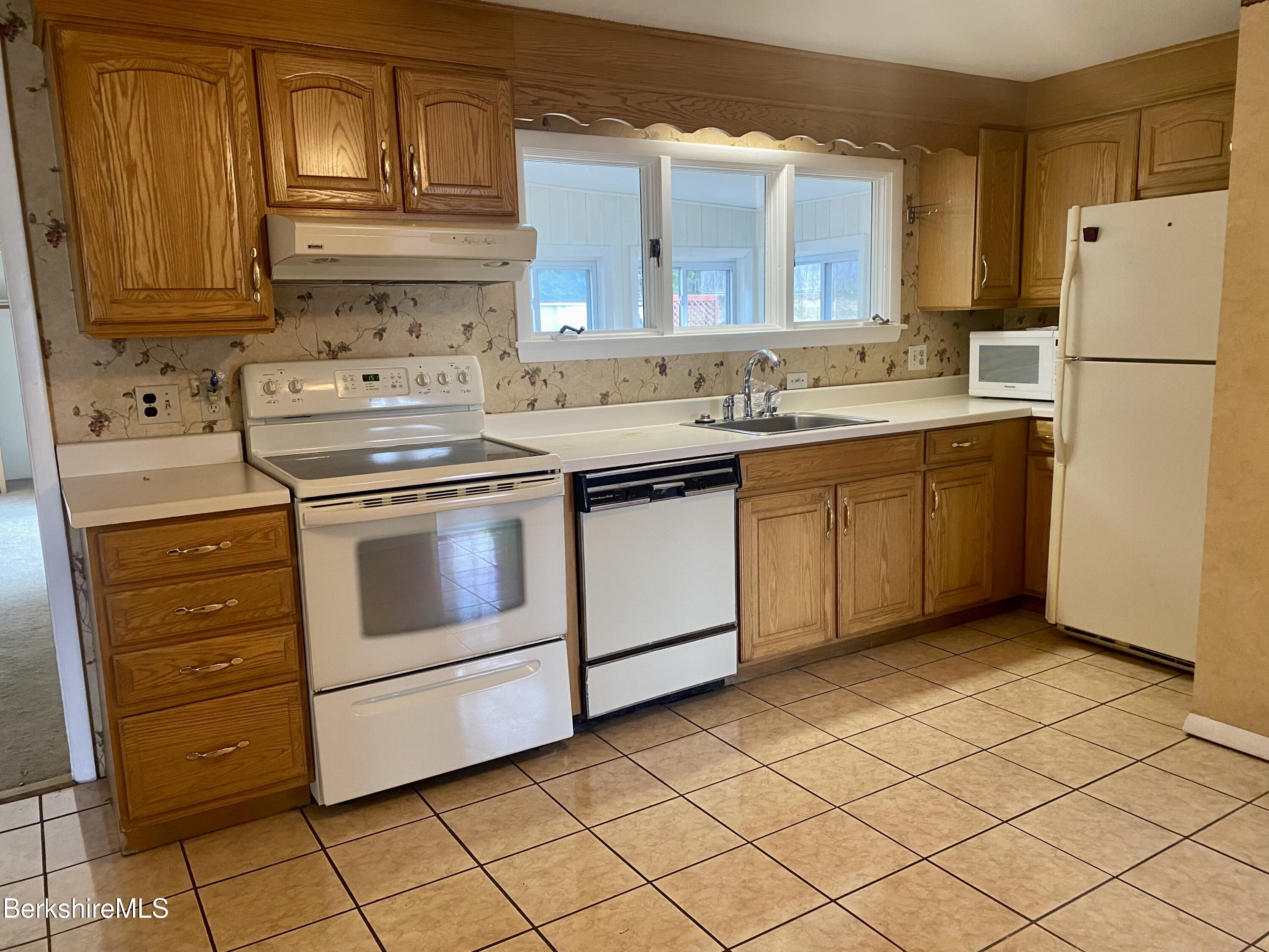 44 Eleanor Road Dalton, MA 01226 - Photo 6 of 36 a kitchen with a stove sink and cabinets