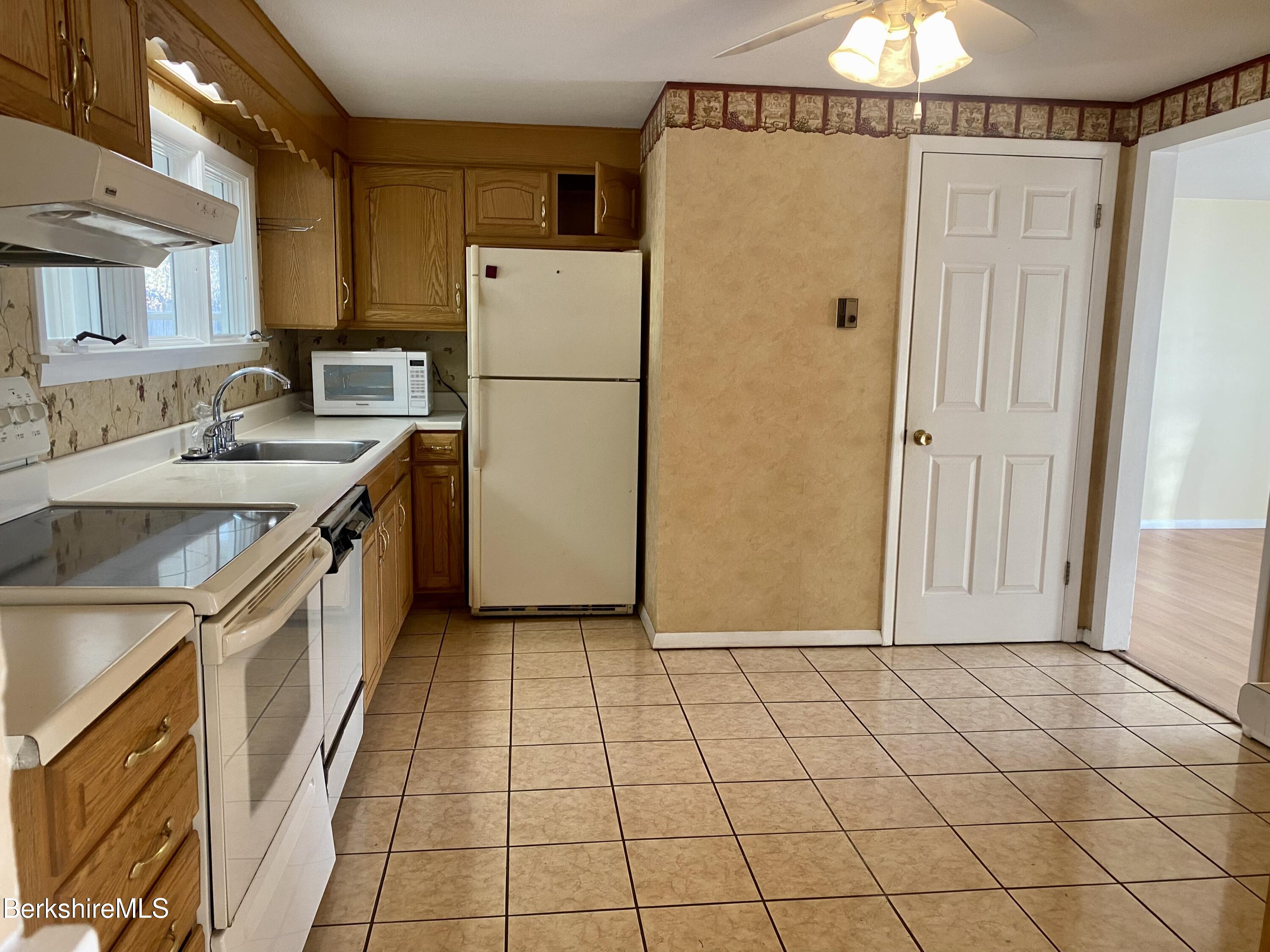 44 Eleanor Road Dalton, MA 01226 - Photo 7 of 36 a kitchen with a refrigerator a sink and cabinets