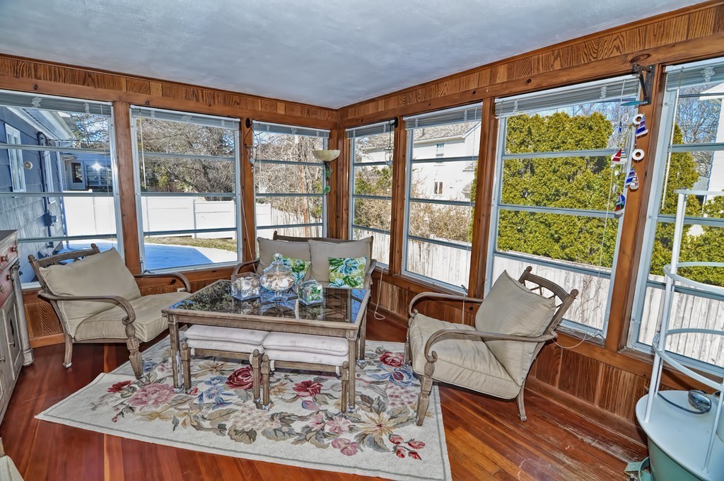 38 Shetland Road Marblehead, MA 01945 - Photo 17 of 23 a living room with large windows and a table