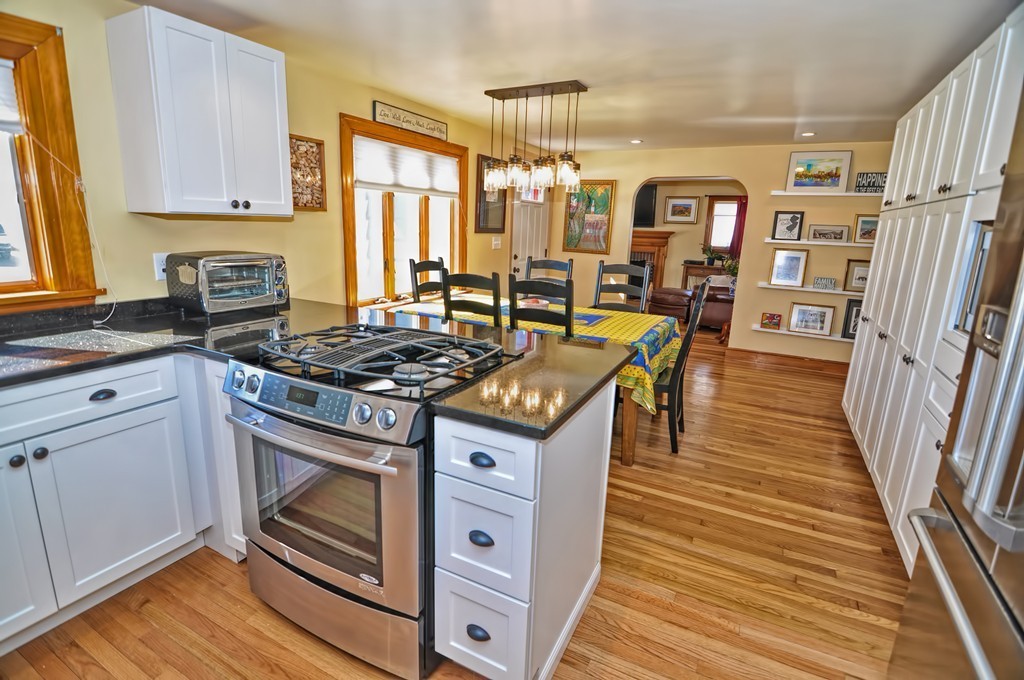 38 Shetland Road Marblehead, MA 01945 - Photo 9 of 23 a kitchen with granite countertop a stove and a wooden floors