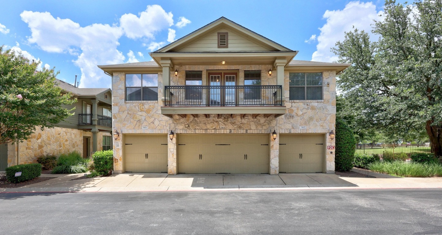 a front view of a house with a garden and trees