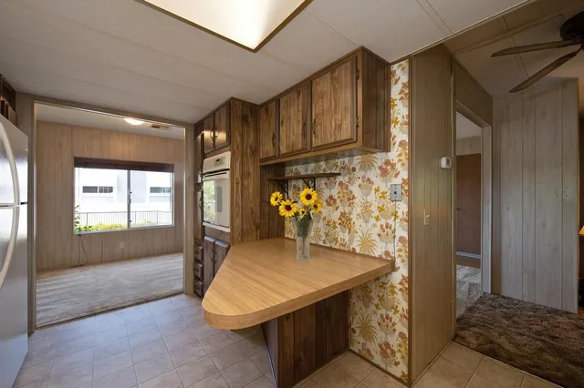 a kitchen with refrigerator and window