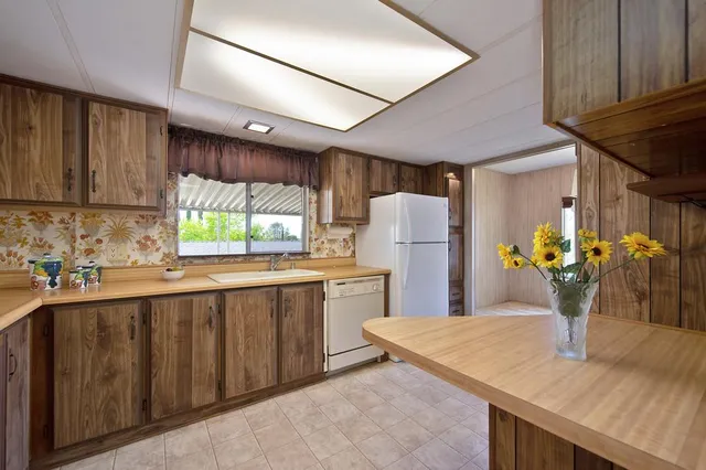 a view of an empty room with large windows