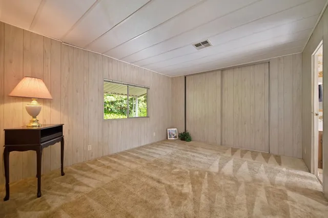 a view of a room with a mirror and a fan