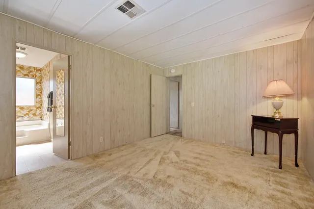 a bathroom with a tub sink and mirror