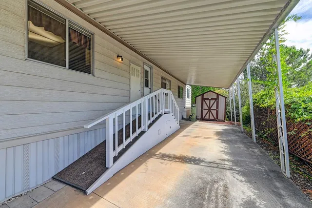 a view of wooden house with a sink and wooden fence