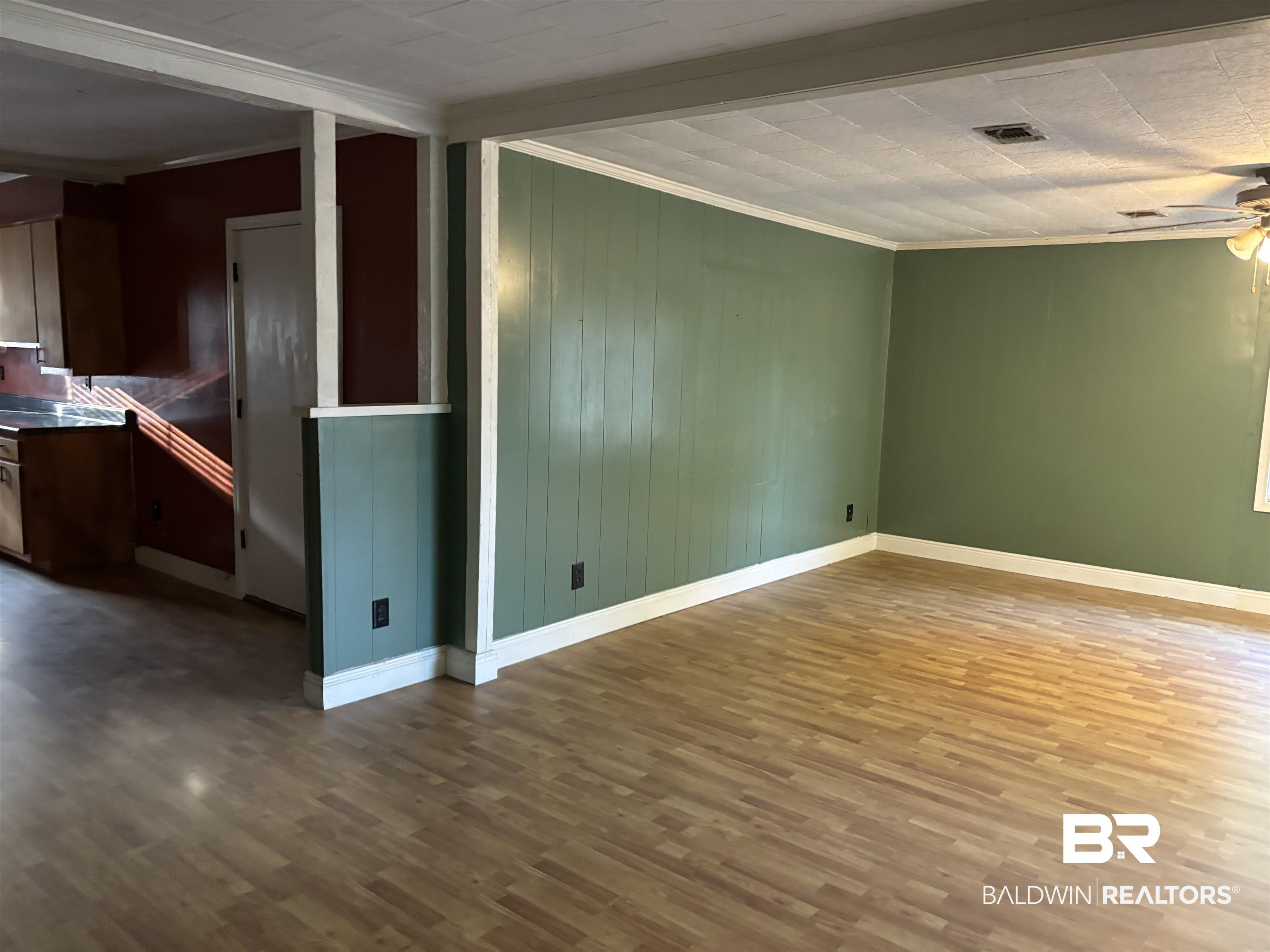 17495 County Road 48 Robertsdale, AL 36567 - Photo 24 of 37 Empty room with crown molding, ceiling fan, and wood-type flooring