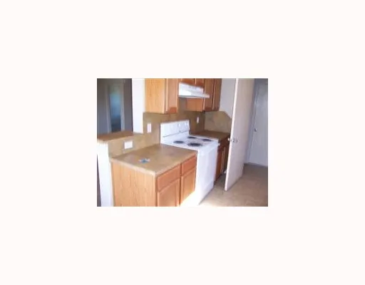 a kitchen with a sink cabinets and a window