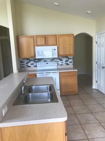 a kitchen with a sink and a refrigerator