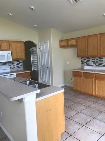 a kitchen with stainless steel appliances granite countertop a sink and a stove