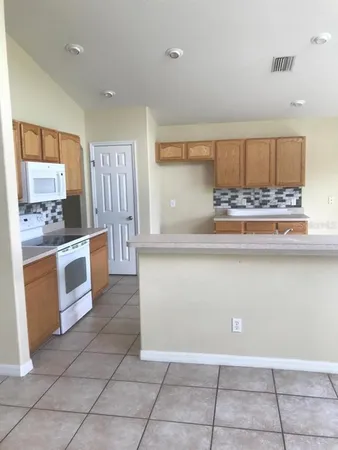 a kitchen with a cabinets and appliances