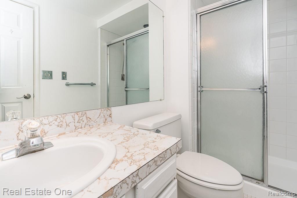 2355 Hillendale Drive Rochester, MI 48309 - Photo 23 of 44 Bathroom vanity with an integrated sink, patterned countertop, and chrome faucet