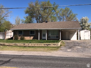 1615 Pioneer Road Draper, UT 84020 - Photo 3 of 13 Single-story residence featuring a brown shingle roof, tan brick exterior, and a covered carport