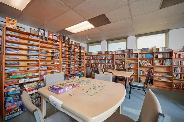 a work room with furniture and a book shelf
