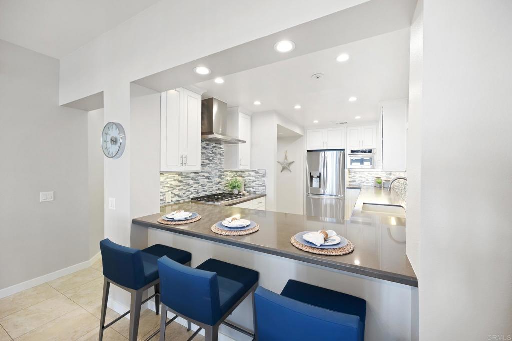 111 Sequoia Avenue, Unit C Carlsbad, CA 92008 - Photo 9 of 38 a large kitchen with dining table and chairs