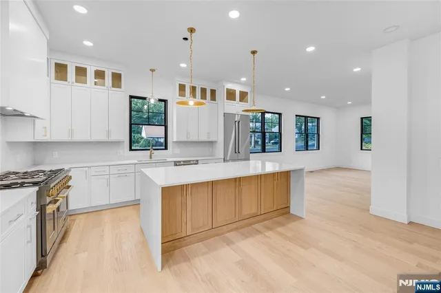 a bathroom with a granite countertop sink toilet a mirror and shower