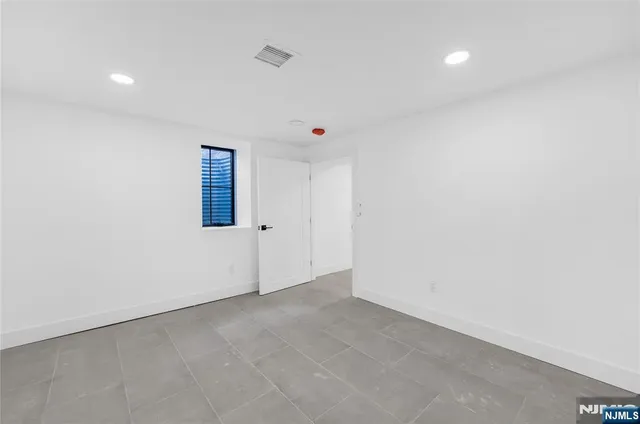 a bathroom with a bathtub sink and mirror