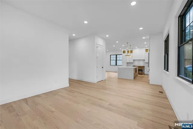 a large kitchen with stainless steel appliances kitchen island a large counter top stove a sink dishwasher and a refrigerator