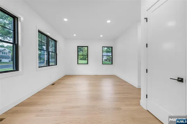 a large kitchen with cabinets and wooden floor