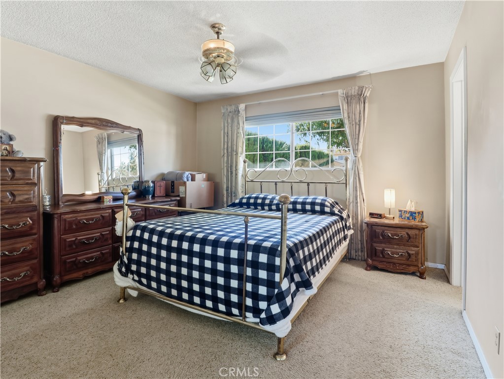 10930 Rio Hondo Drive Downey, CA 90241 - Photo 13 of 30 a bedroom with a bed and dresser with mirror
