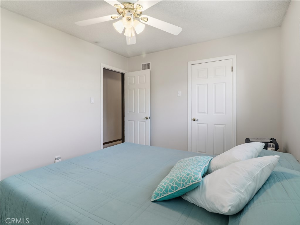 10930 Rio Hondo Drive Downey, CA 90241 - Photo 17 of 30 a bedroom with a bed and a chandelier