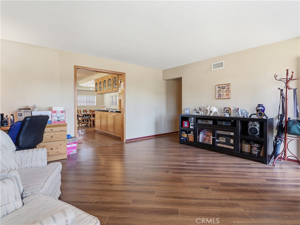10930 Rio Hondo Drive Downey, CA 90241 - Photo 4 of 30 a living room with furniture and hard wood flooring