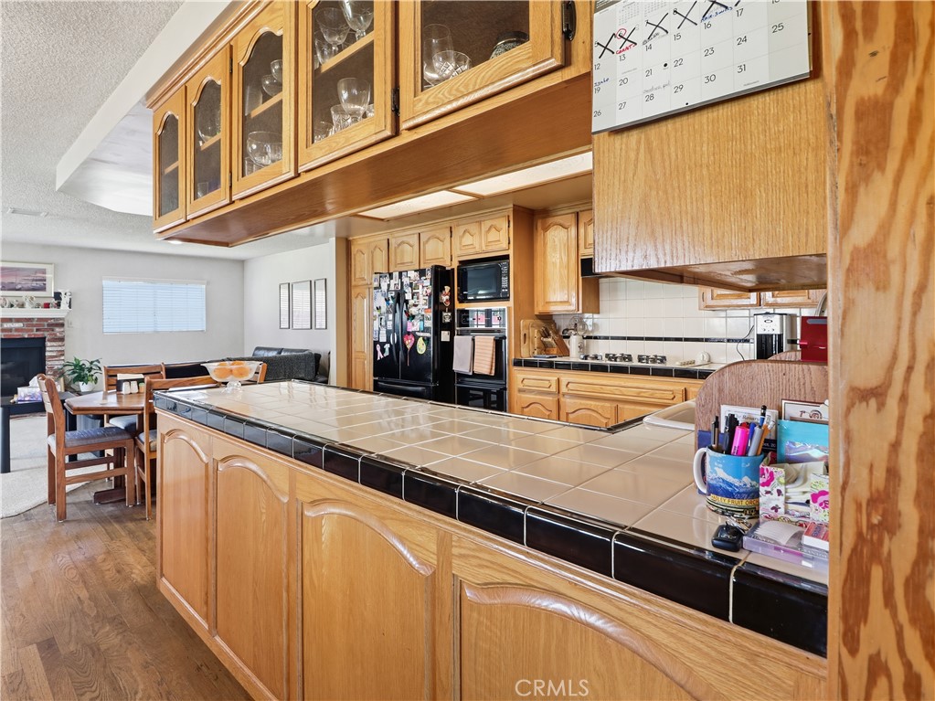 10930 Rio Hondo Drive Downey, CA 90241 - Photo 9 of 30 a kitchen with stainless steel appliances granite countertop a lot of counter space and cabinets