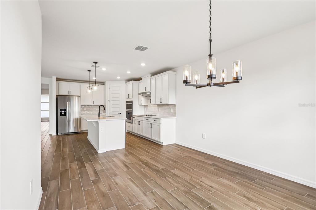 3335 Orchard Loop Bartow, FL 33830 - Photo 11 of 47 a view of a kitchen with a sink and wooden floor