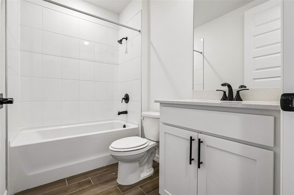 3335 Orchard Loop Bartow, FL 33830 - Photo 18 of 47 a bathroom with a bathtub shower sink vanity and toilet