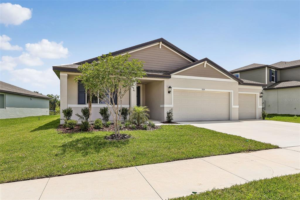 3335 Orchard Loop Bartow, FL 33830 - Photo 2 of 47 a front view of a house with a yard