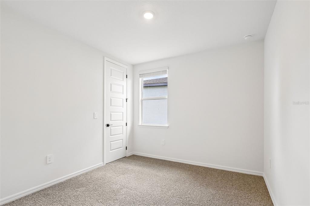 3335 Orchard Loop Bartow, FL 33830 - Photo 23 of 47 an empty room with windows and closet