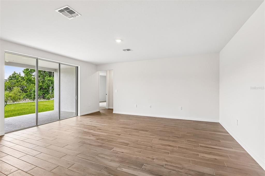3335 Orchard Loop Bartow, FL 33830 - Photo 7 of 47 a view of an empty room with wooden floor and a window