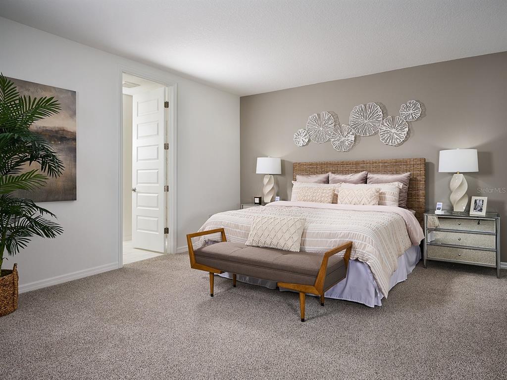 3335 Orchard Loop Bartow, FL 33830 - Photo 7 of 7 a spacious bedroom with a bed and a potted plant