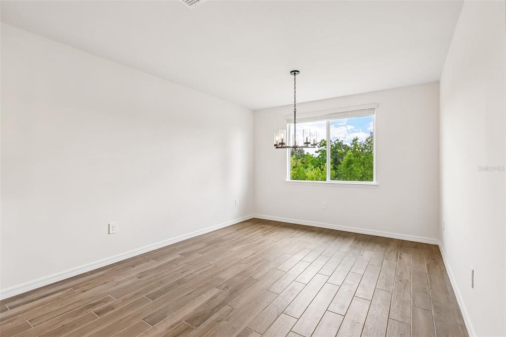 3335 Orchard Loop Bartow, FL 33830 - Photo 9 of 47 an empty room with wooden floor and windows