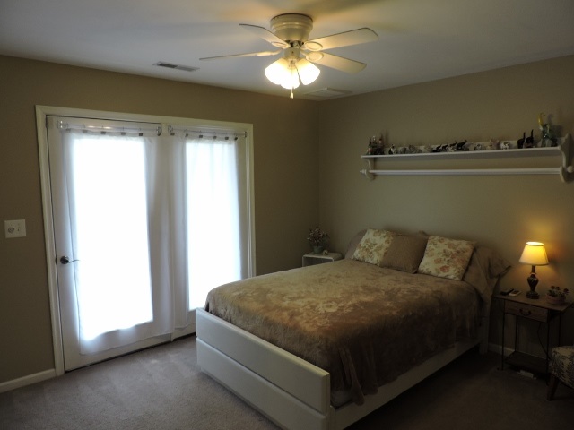83 Willow Spout Road Fort Defiance, VA 24437 - Photo 23 of 48 a bedroom with a bed and a chandelier