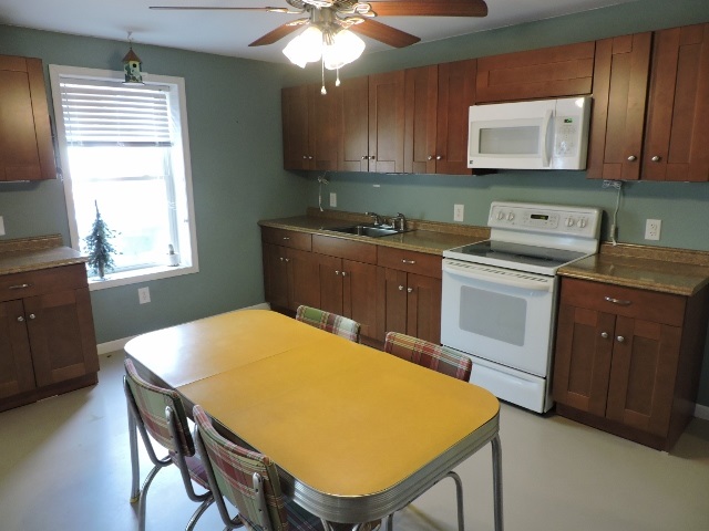 83 Willow Spout Road Fort Defiance, VA 24437 - Photo 26 of 48 a kitchen with a table chairs sink and cabinets