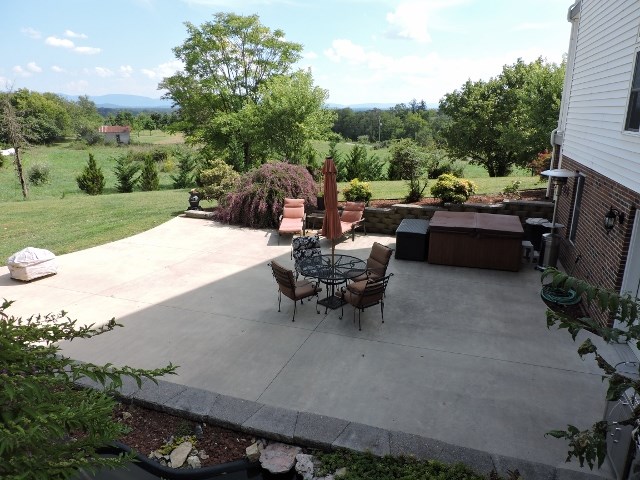 83 Willow Spout Road Fort Defiance, VA 24437 - Photo 33 of 48 a view of a patio with table and chairs with a garden