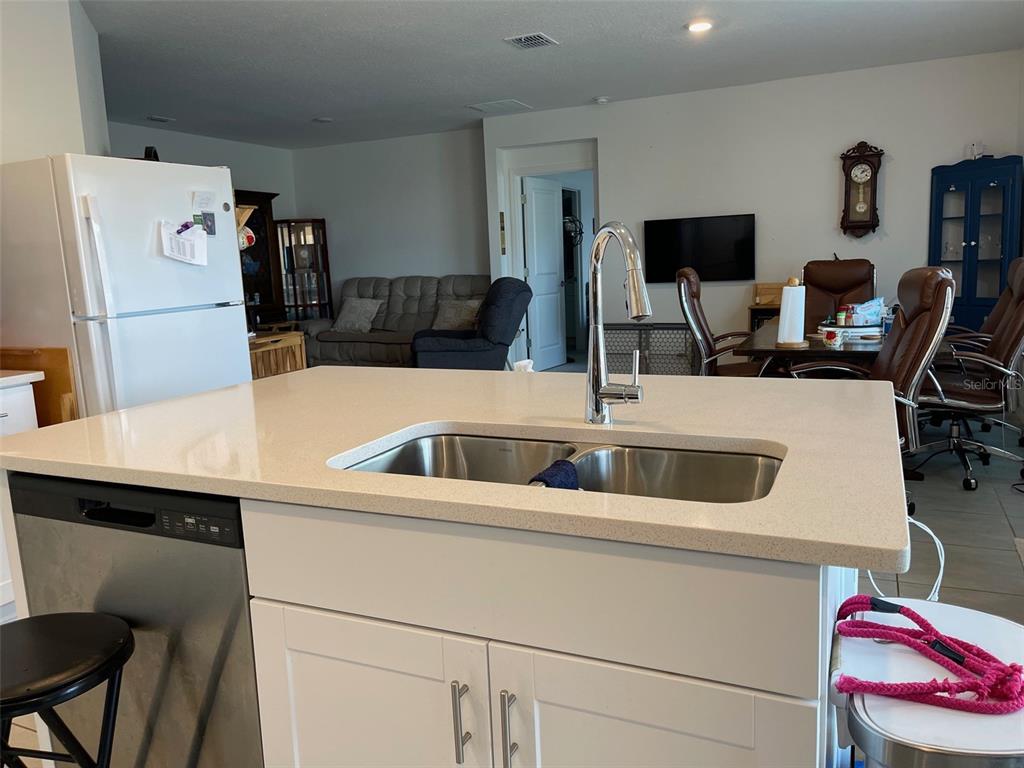 365 River Front Way Edgewater, FL 32141 - Photo 14 of 34 a kitchen with a sink and a refrigerator