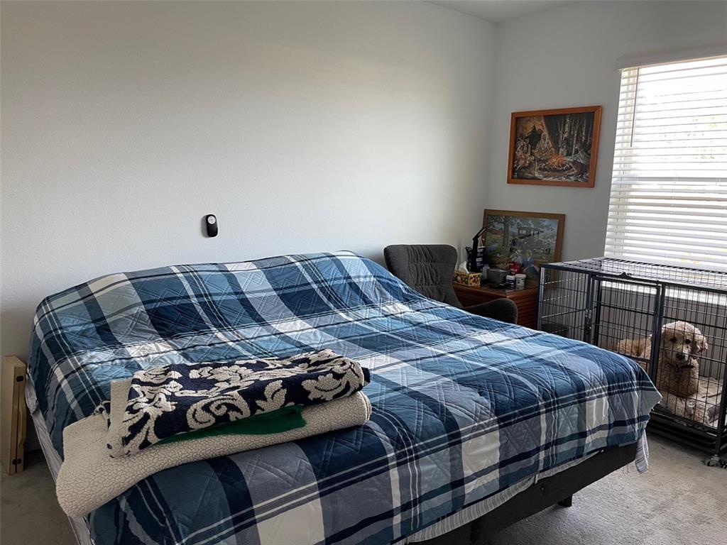 365 River Front Way Edgewater, FL 32141 - Photo 15 of 34 a bedroom with a bed and a chair