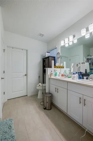 a spacious bathroom with a double vanity sink and a mirror