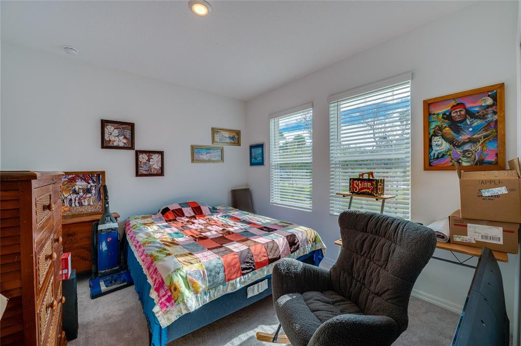 365 River Front Way Edgewater, FL 32141 - Photo 17 of 34 a bedroom with a bed couch and a window