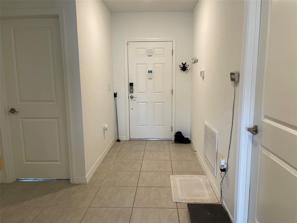 365 River Front Way Edgewater, FL 32141 - Photo 6 of 34 a view of a livingroom with wooden floor and a hallway