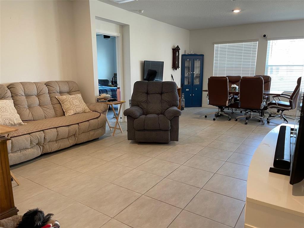 365 River Front Way Edgewater, FL 32141 - Photo 7 of 34 a living room with furniture and a flat screen tv