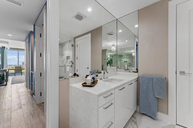 a kitchen with stainless steel appliances a table chairs and white cabinets