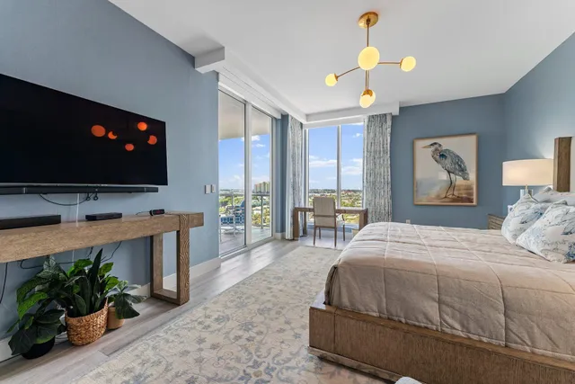 a bedroom with a bed and a lamp on dresser